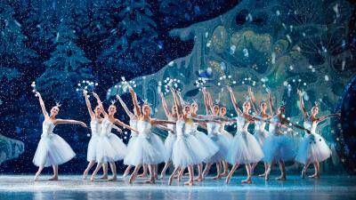 ballet dancers in long white tutu on a winter forest background with snow falling