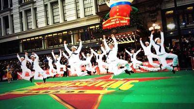 "On The Town" dancers in a jump at the Macy's Thanksgiving Day Parade