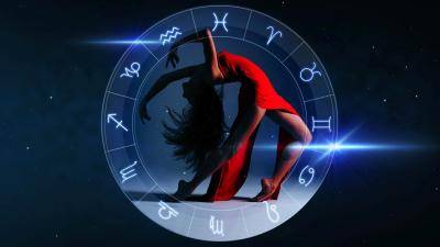 dancer in a red dress arching back