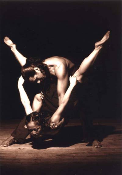 Alex Magno holding dance partner low to the ground as she plunges forward