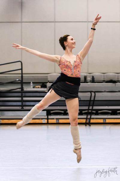 ballet dancer Maggie Rupp jumping in a studio rehearsal