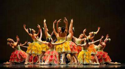 corps de ballet in shades of pink, yellow and green, in a circle shape forming a flower