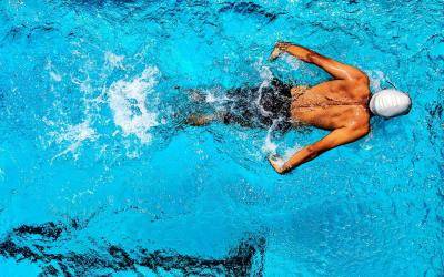 aerial view of a swimmer in a bright blue pool