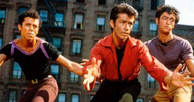 George Chakiris (Bernardo) in a red shirt and two other dancers in a scene from West Side Story