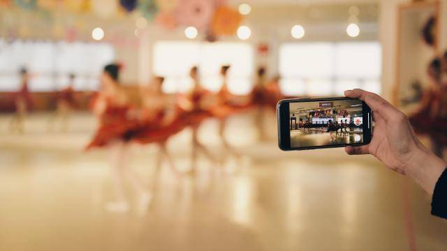 Group of ballet dancers in rehearsal being filmed on a phone